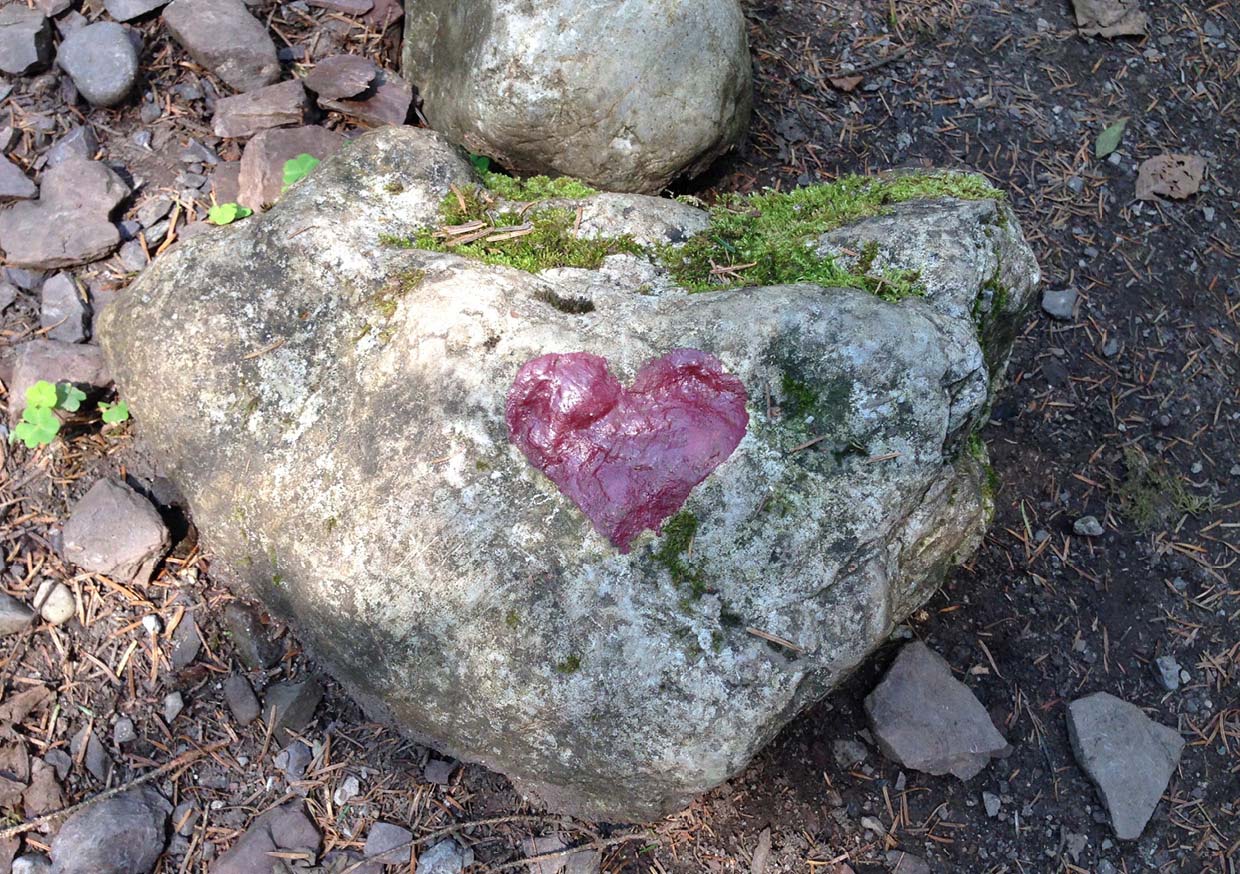 Photo of a stone with a heart painted on it.